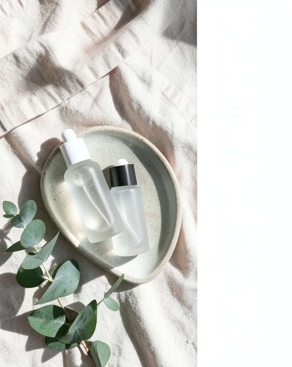 Clean beauty product flat lay with serum bottles on a soft neutral background
