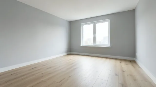 Empty modern living room with light gray walls and oak flooring ready for staging