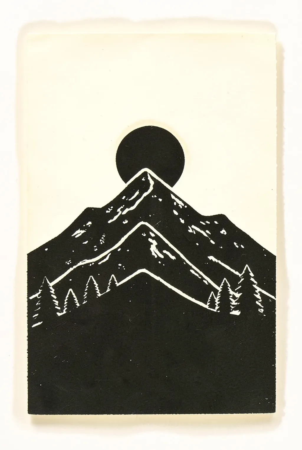 Single-colour linocut print of layered mountain ridges with carved white gouge marks on cream paper