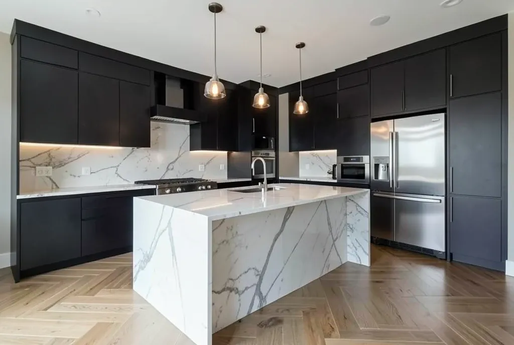 Luxury modern kitchen with marble waterfall island, pendant lights, dark cabinets, and herringbone floors