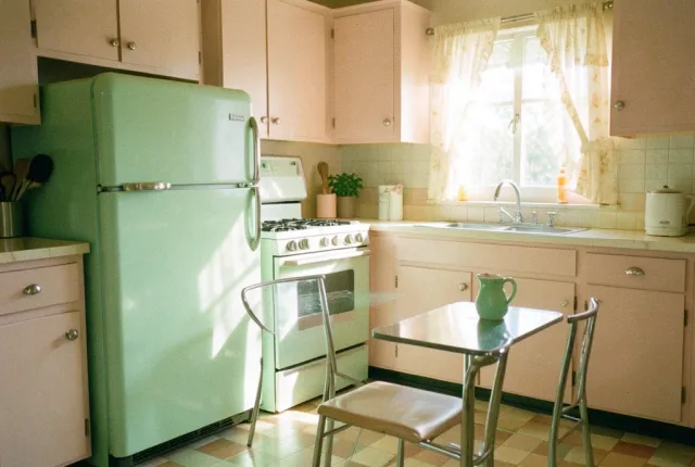 A pastel 1950s kitchen with mint appliances in morning sun