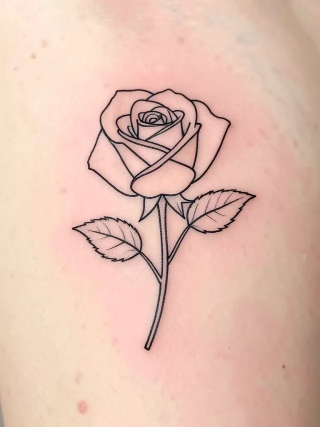 Fine single-line black ink rose tattoo with leaves and a stem on a soft skin-tone background, no shading