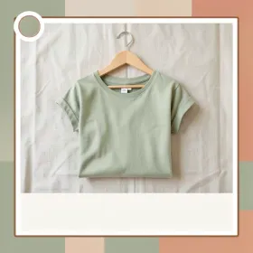 Social media brand template with folded organic cotton tee on hanger against linen in oat sage and terracotta