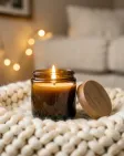 A lit amber jar soy candle in cozy hygge styling — AI-generated example render