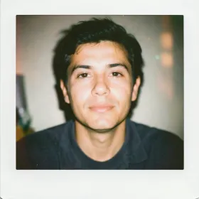 Candid vintage instant-film portrait with soft washed colors, gentle flash and subtle grain