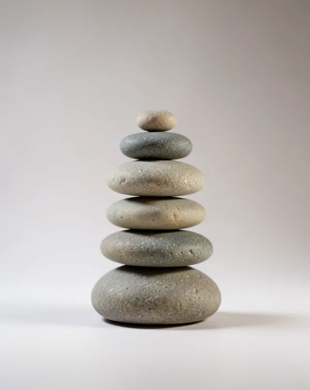 A balanced zen stone stack on a soft gradient backdrop